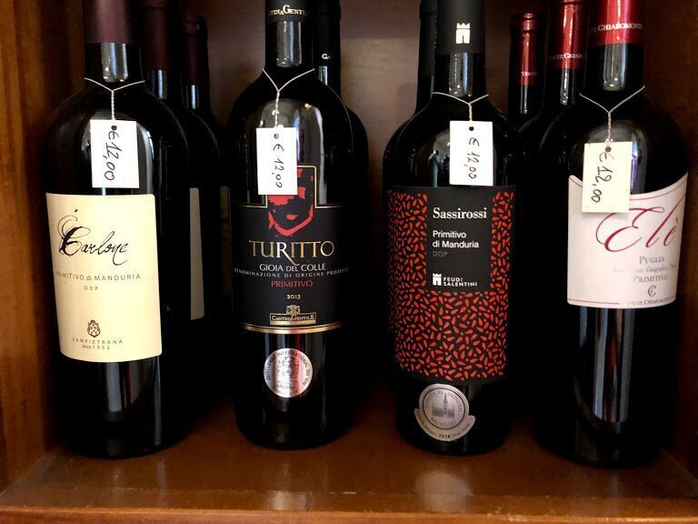 Variants of Primitivo from Puglia on the shelf of the wine cellar