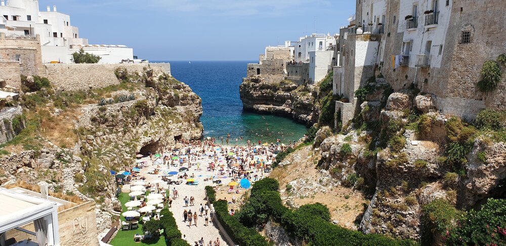 Tourists flock to Polignano for this white rock beach