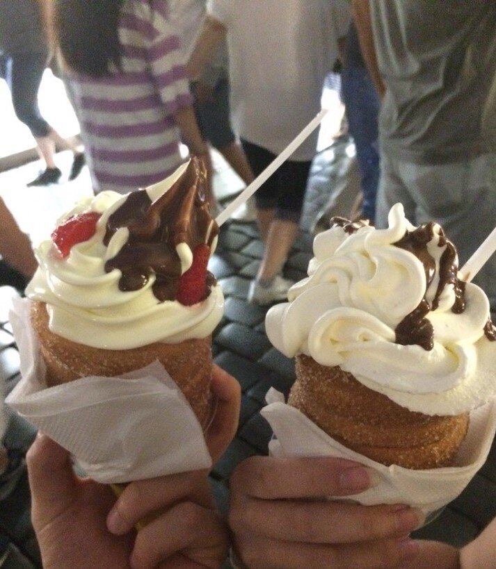 Trdelnik on the left with ice cream and fresh berries, on the right with ice cream