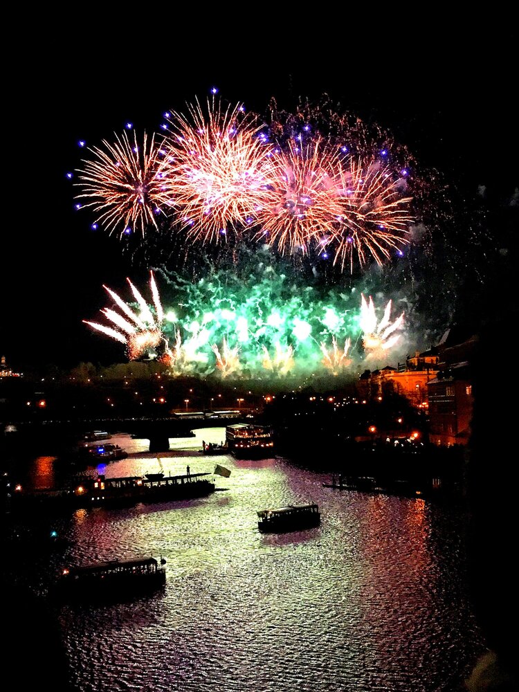 Fireworks on January 1. View from Charles Bridge. There are boats on the Vltava River